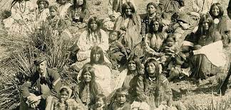 Apache women and children prisoners seated with two American soldiers, 1881. (SPC Sw Apache NAA 4877 Baker & Johnston 02027700, National Anthropological Archives, Smithsonian Institution