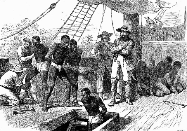 Captive Africans being transferred to ships along the Slave Coast for the transatlantic slave trade, c. 1880. Credit Photos com Getty Image