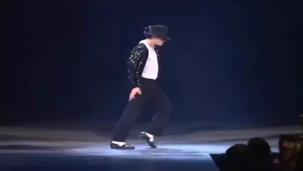 Michael Jackson performing the infamous moonwalk.