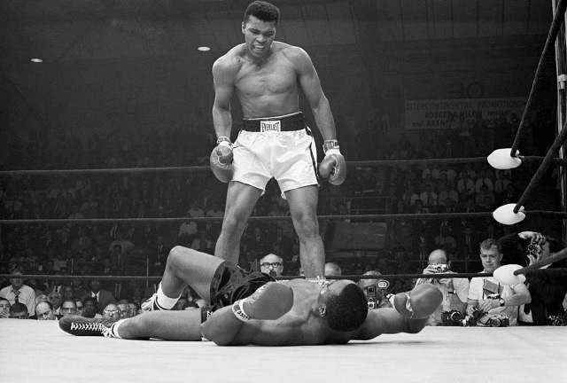 Muhammad Ali looks down on Sonny Liston in the World Heavyweight Championship Rematch in what has become an iconic photo. Credit: Getty Images.