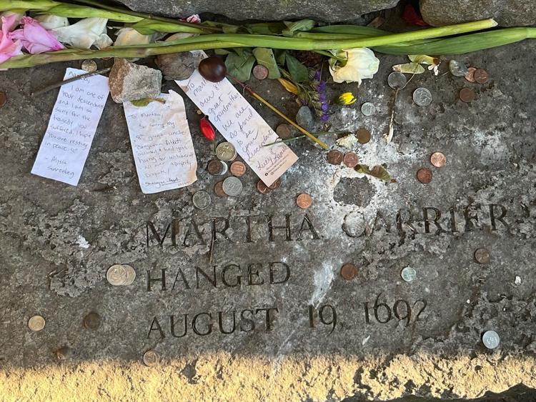 The tomb stone of a victim of the Salem Witch Trials at the memorial. One of the notes on this tombstone is from the descendant of a witch accuser, Benjamin Abbot. The descendant is apologizing for the actions of his ancestor who accused the victim of being a witch leading to her death.