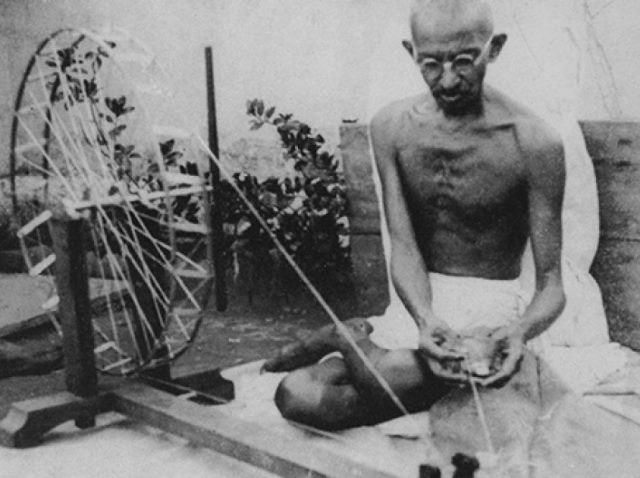 Mahatma Gandhi spinning yarn, in the late 1920s. 